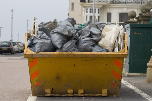 Front view of an office space with clearance team preparing materials in Maidavale